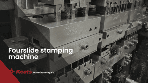 Fourslide stamping machine at Keats Manufacturing Co. for precision metal forming.