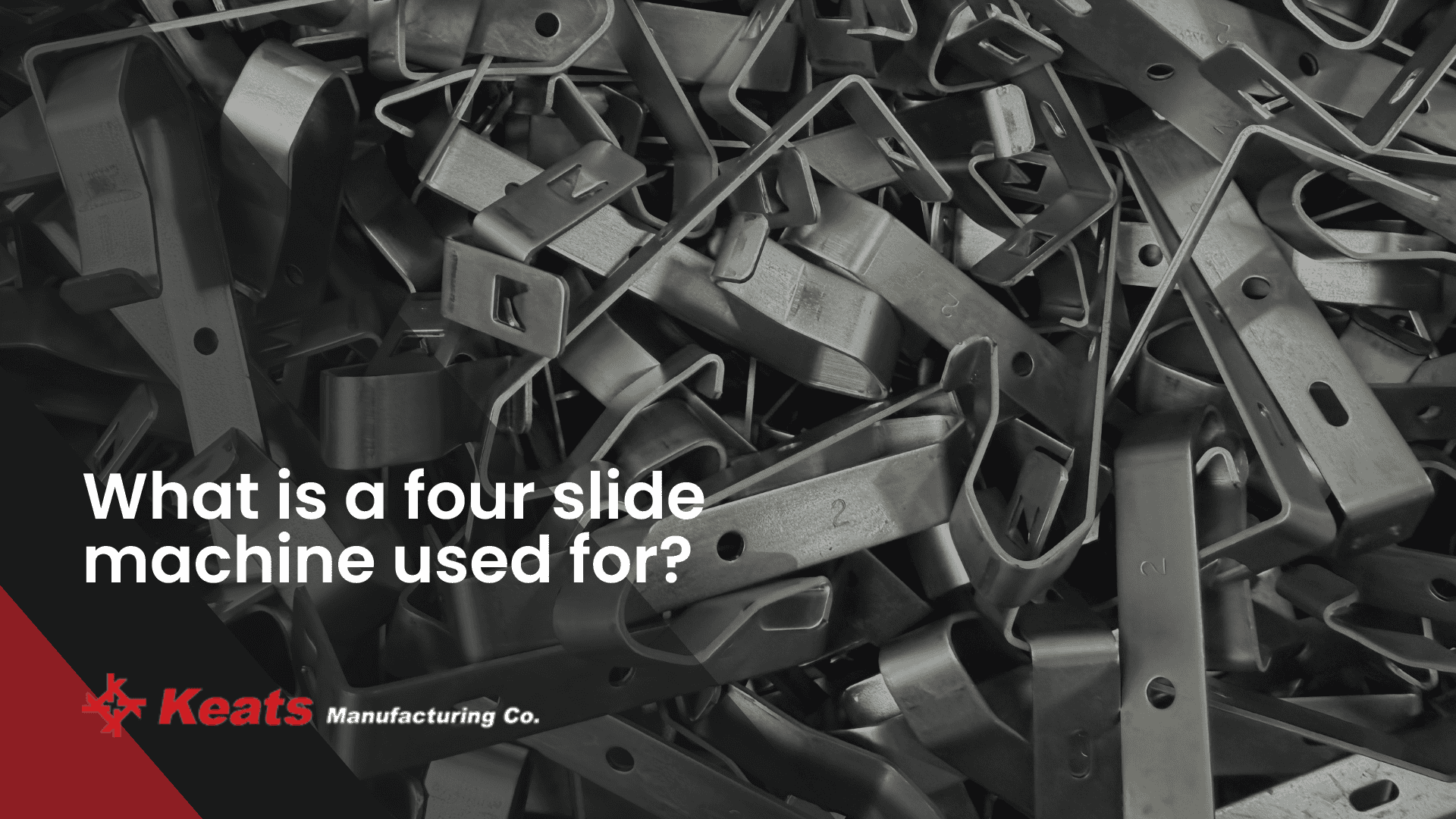 Close-up of various metal parts used in four-slide machines at Keats Manufacturing.